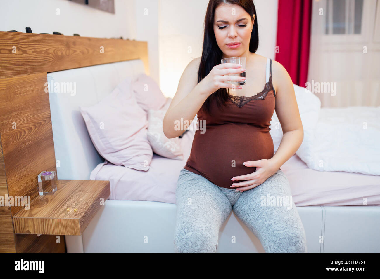 Pregnant woman staying hydrated and drinking plenty fluids Stock Photo