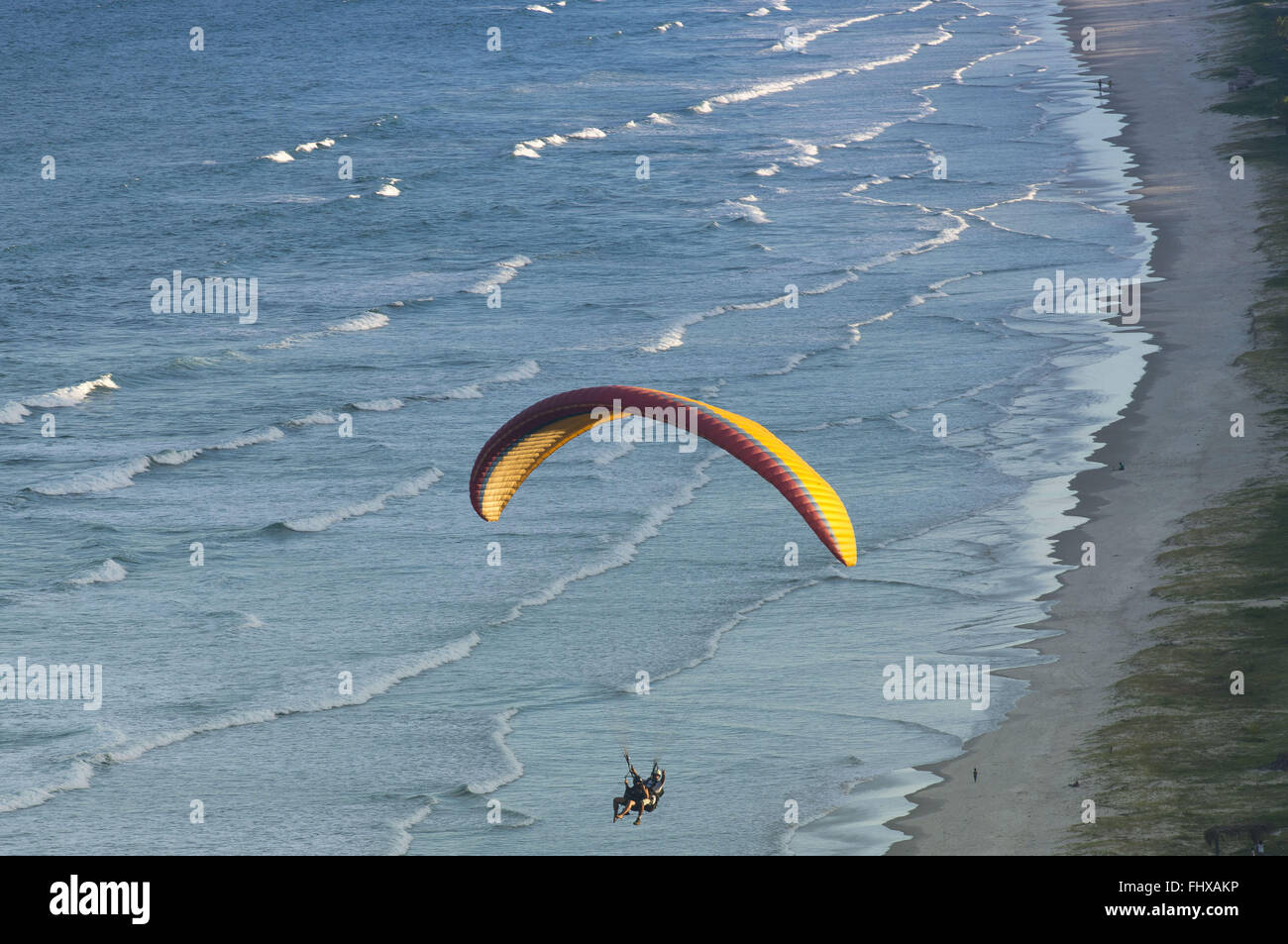 Paraglider flying over the beach Pe de Serra Stock Photo