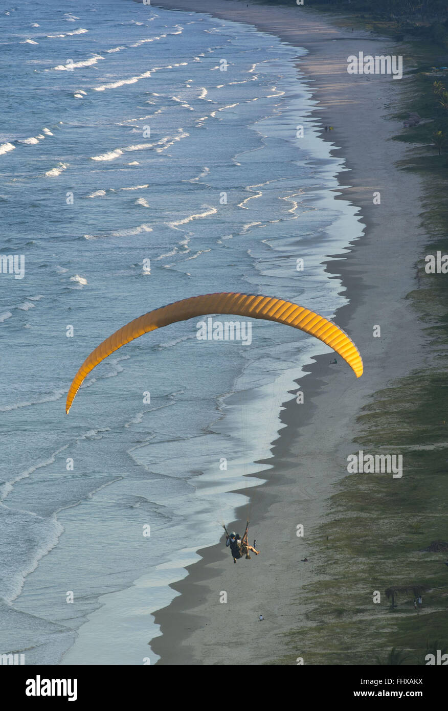 Paraglider flying over the beach Pe de Serra Stock Photo