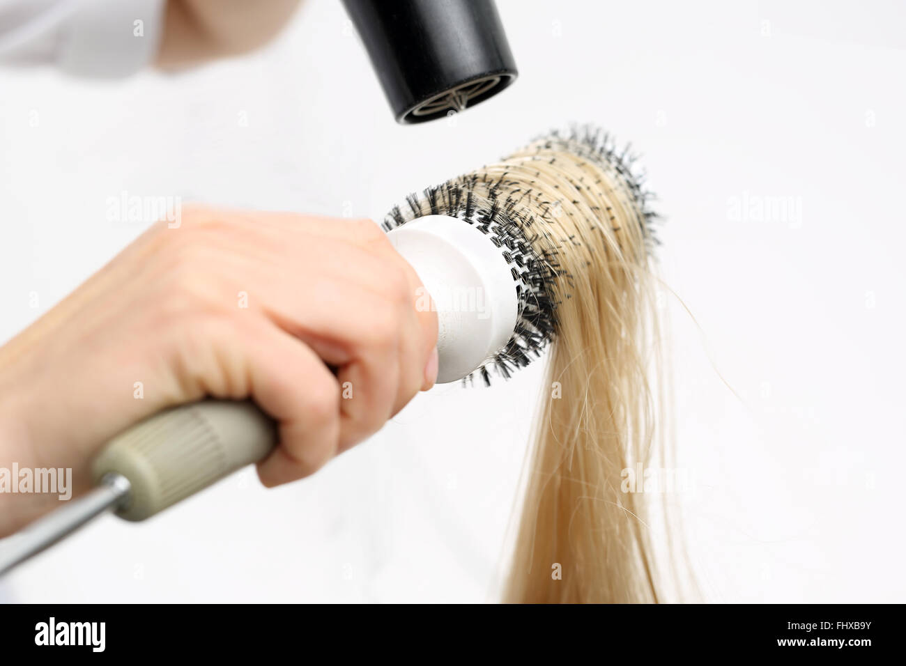 Combing the hair drying brush. The woman at the hairdresser, barber