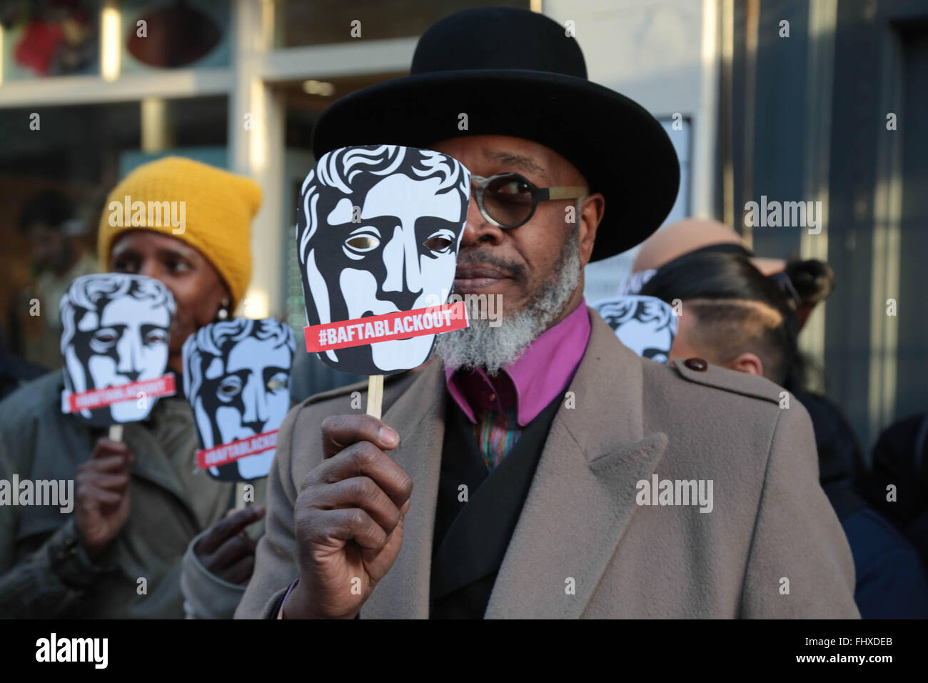 Leon Herbert holds a placard out side the Royal Opera house in protest at the lack of diversity in the Brtish film industry a BAFTA Awards. Stock Photo