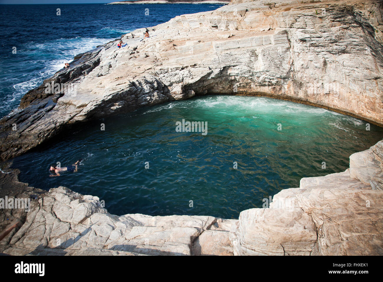 Top view of woman swimming in natural sea water pool. Stock Photo