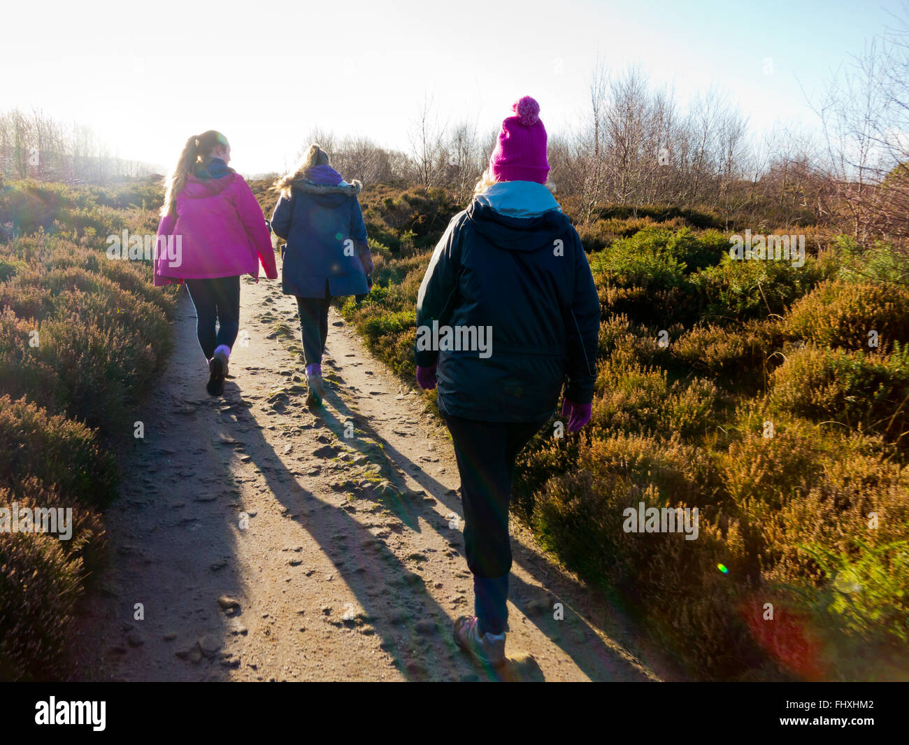 Family walking in winter on Stanton Moor near Matlock in the Peak District Derbyshire Dales England UK Stock Photo