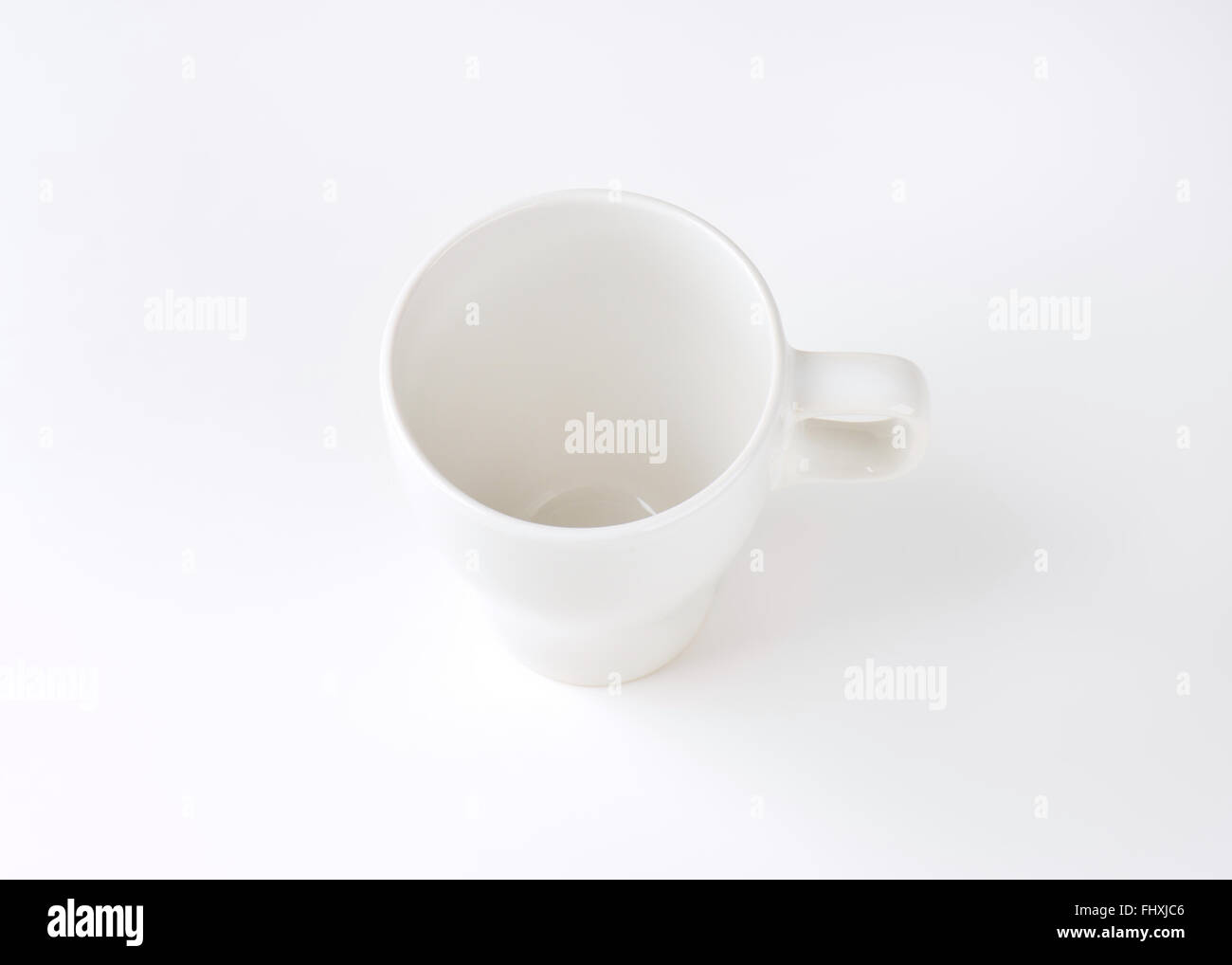empty white mug on white background Stock Photo - Alamy