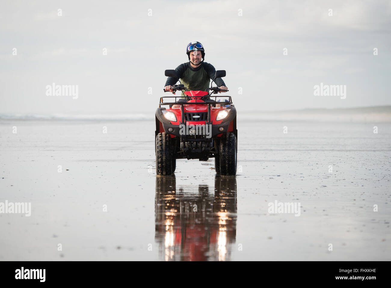 Happy ATV driver on the Ninety Mile Beach, New Zealand Stock Photo