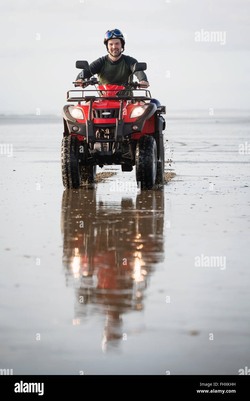 Happy ATV driver on the Ninety Mile Beach, New Zealand Stock Photo