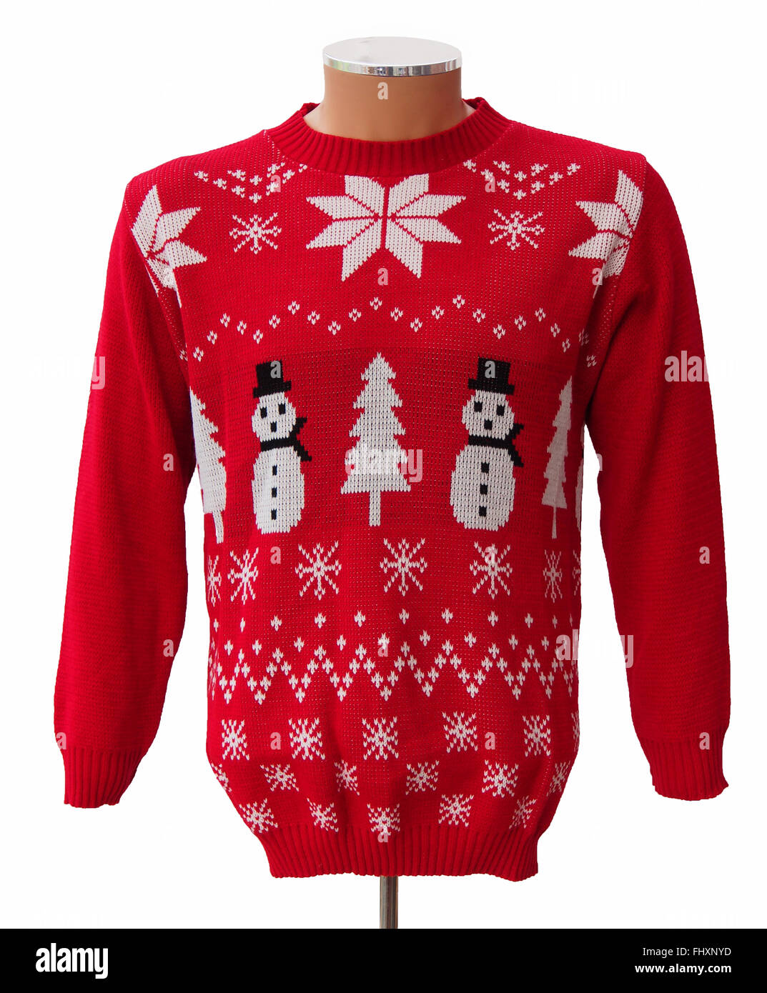 Red and white knitted adults' Christmas jumper, featuring snowmen, Xmas trees and snowflakes, isolated on a white background. Stock Photo