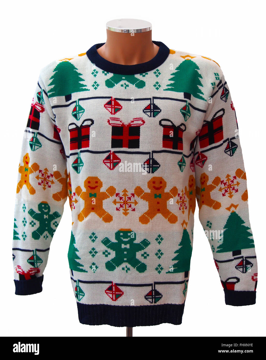Traditional knitted adults' Christmas jumper, featuring Xmas presents and Xmas trees isolated on a white background. Stock Photo