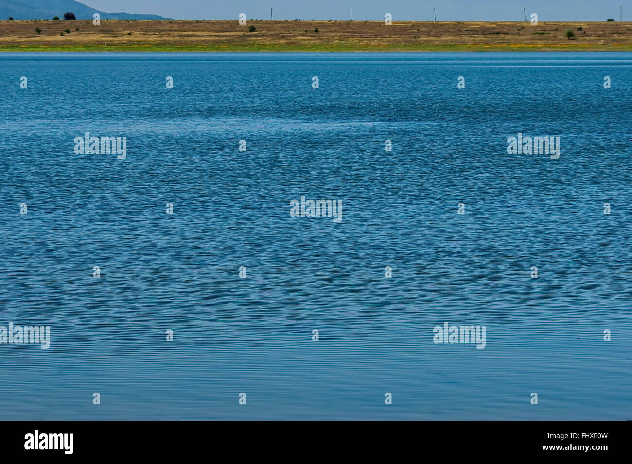 Blue empty water background - empty natural surface at Rabisha  lake, Belogradchik, Bulgaria Stock Photo