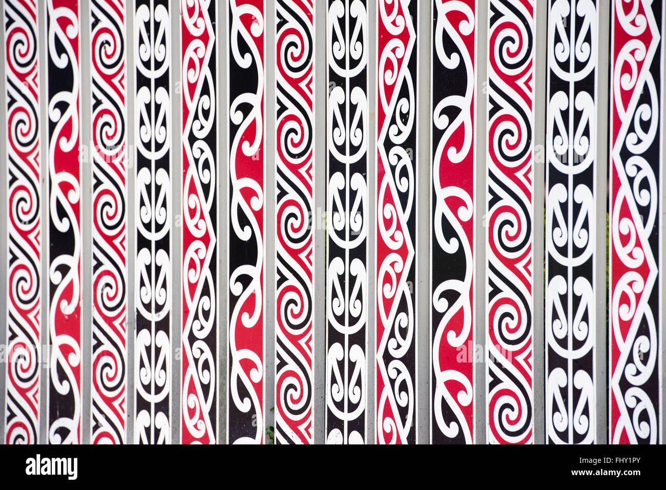 painted Maori decorations on the fence in Rotorua, New Zealand Stock Photo