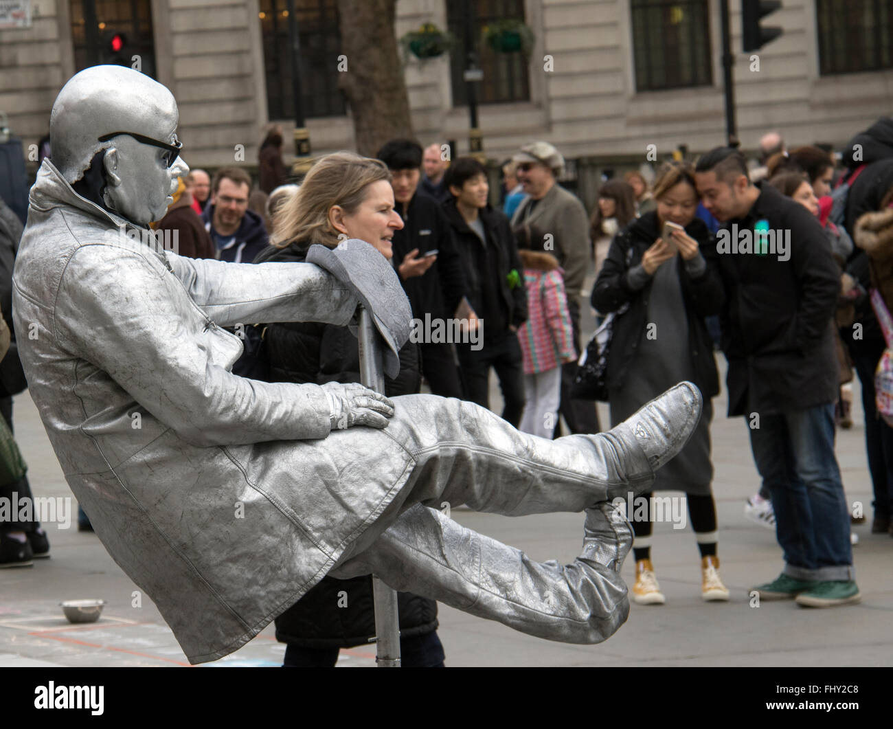 Silver painted street entertainer in London's Trafalgar Square Stock Photo