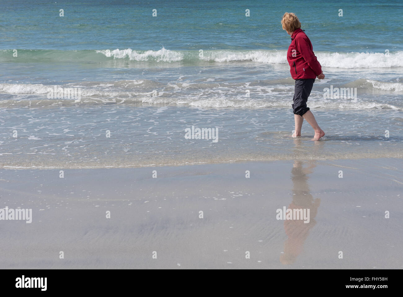 Paddling on the beach near Howmore South Uist Stock Photo