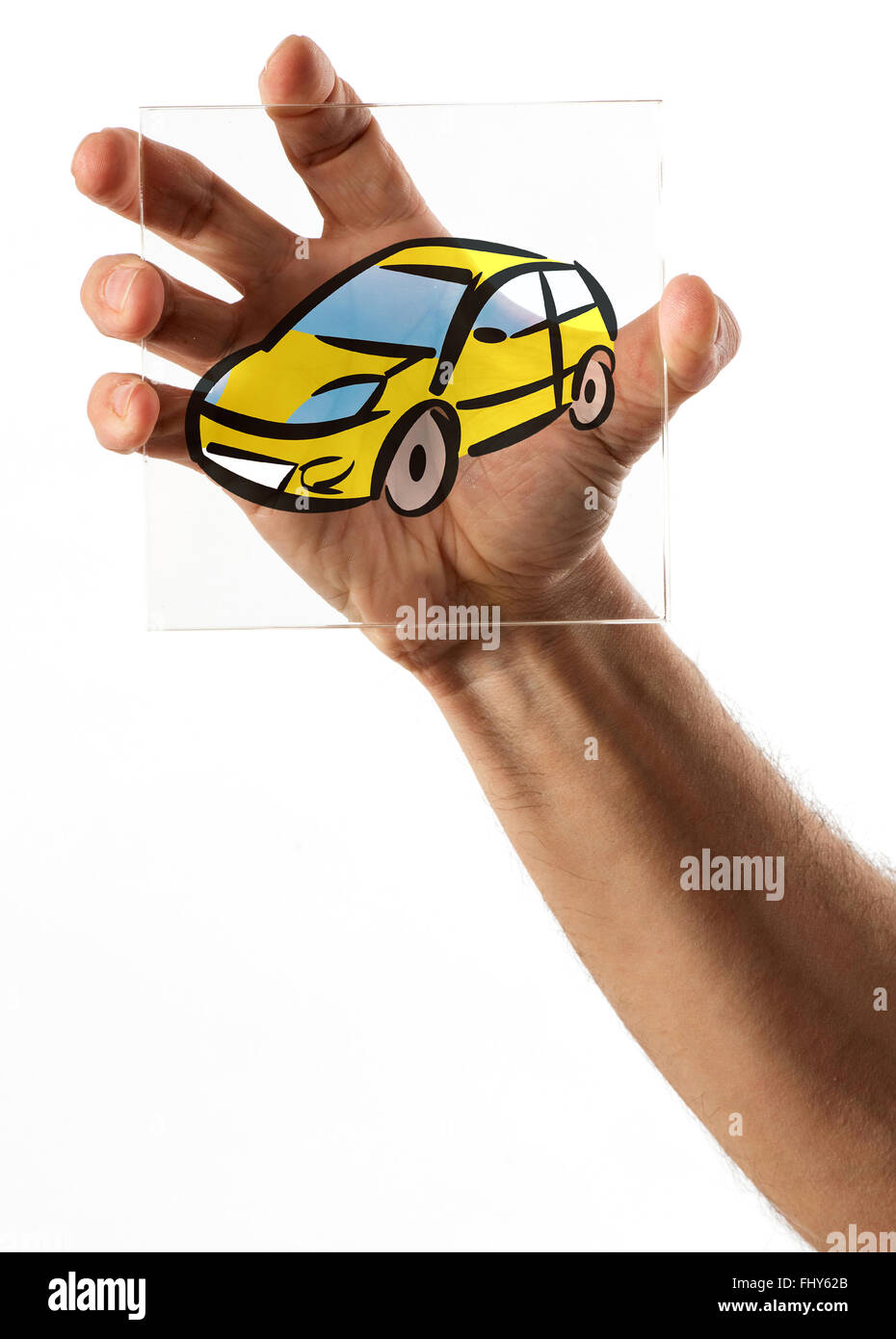 Single hand holding image of yellow cartoon car on square glass plate over white background Stock Photo