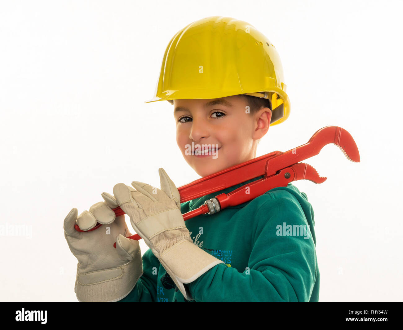 Portrait of boy with hard hat holding large pliers Stock Photo