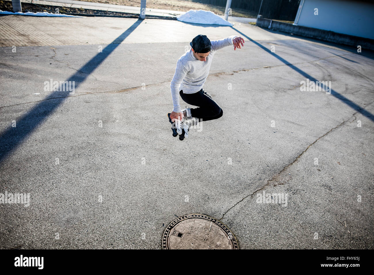 Young man jumping with inlineskates Stock Photo