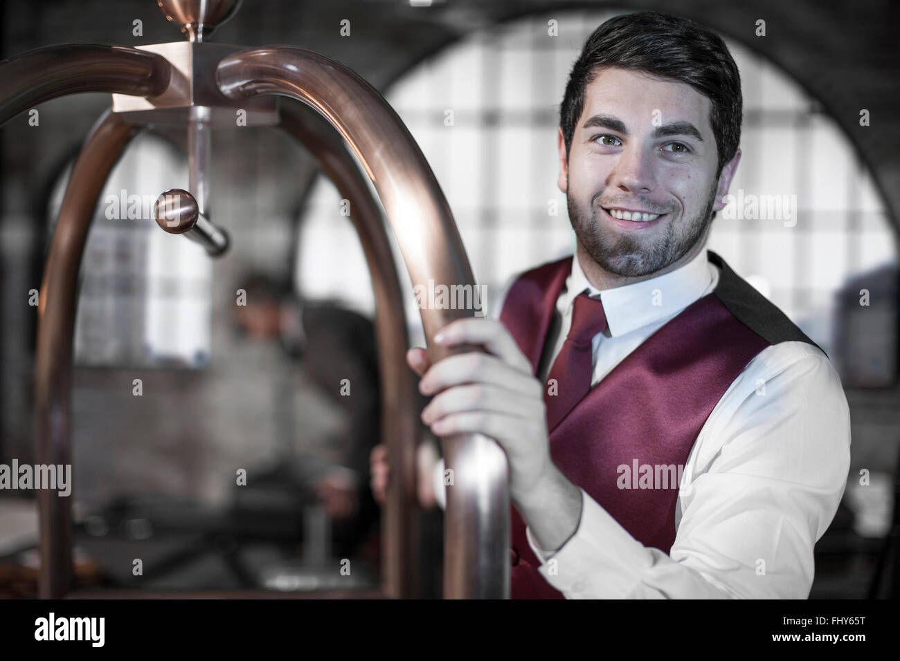 Bellboy with trolley, hotel room Stock Photo