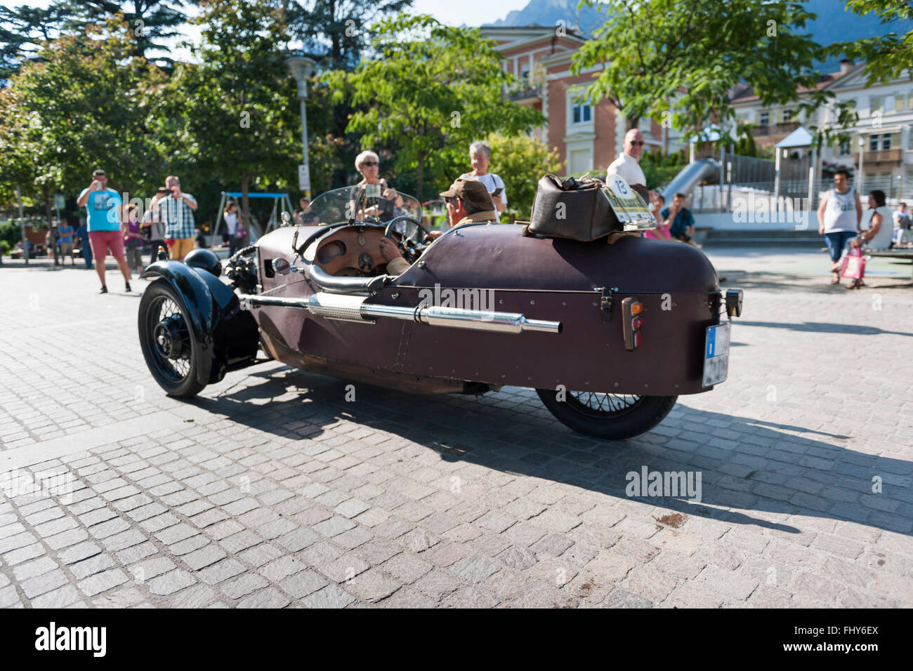Merano, Italy - July 9, 2015: start of the Morgan Three Wheeler super sports with the owner and driver Leonhard Lösch on the sq Stock Photo