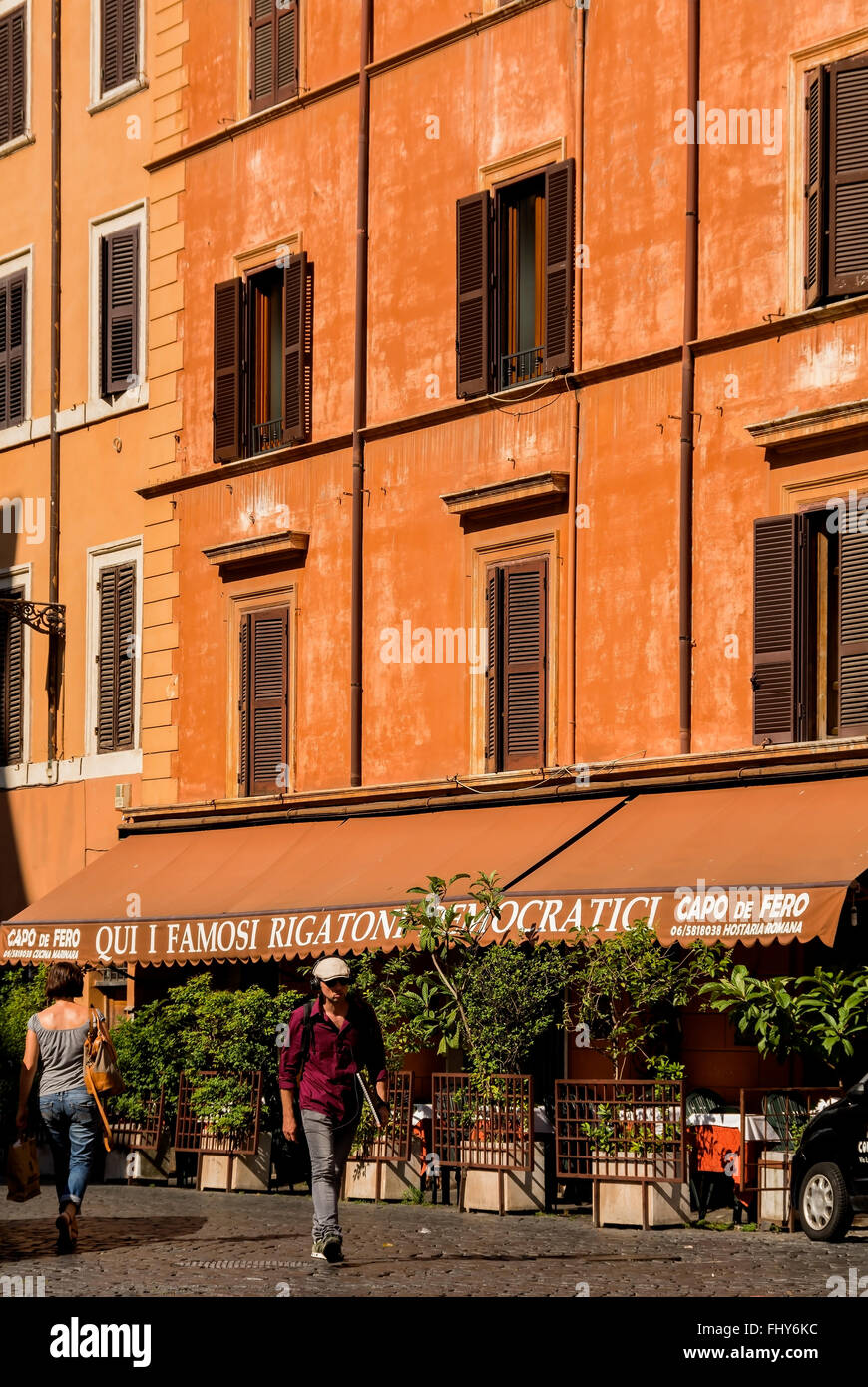 A typical street with stucco'd buildings in Rome, Italy. This is the capo de Fero restaurant on Via San Cosimato. Stock Photo