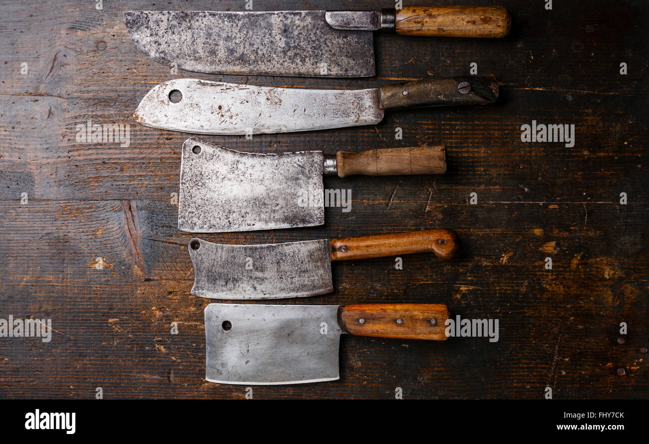 Vintage Butcher meat cleavers on dark wooden background Stock Photo