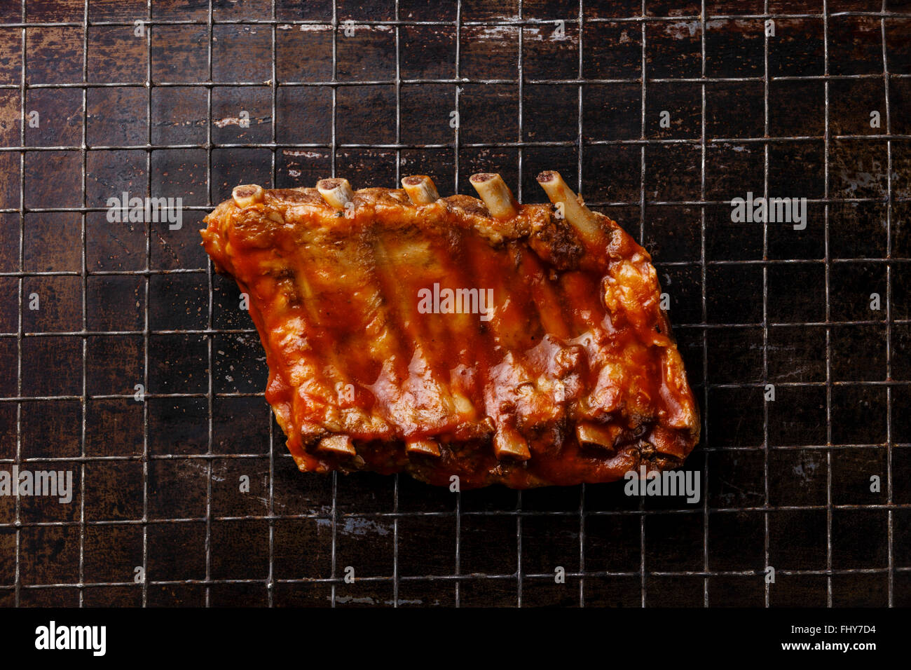 BBQ grilled smoked pork ribs on dark metal baking sheet background Stock Photo