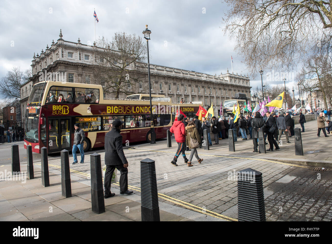 Big Bus London is passing by Kurdish demonstration outside the Downing Street, London, UK. 10th February, 2016. Stock Photo