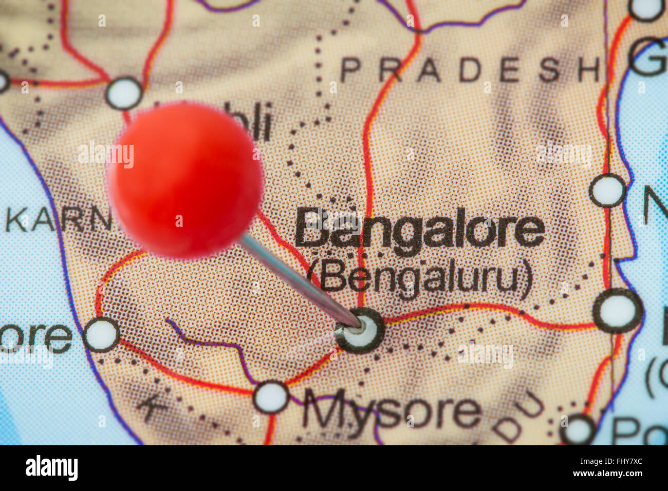Close-up of a red pushpin in a map of Bangalore, India. Stock Photo
