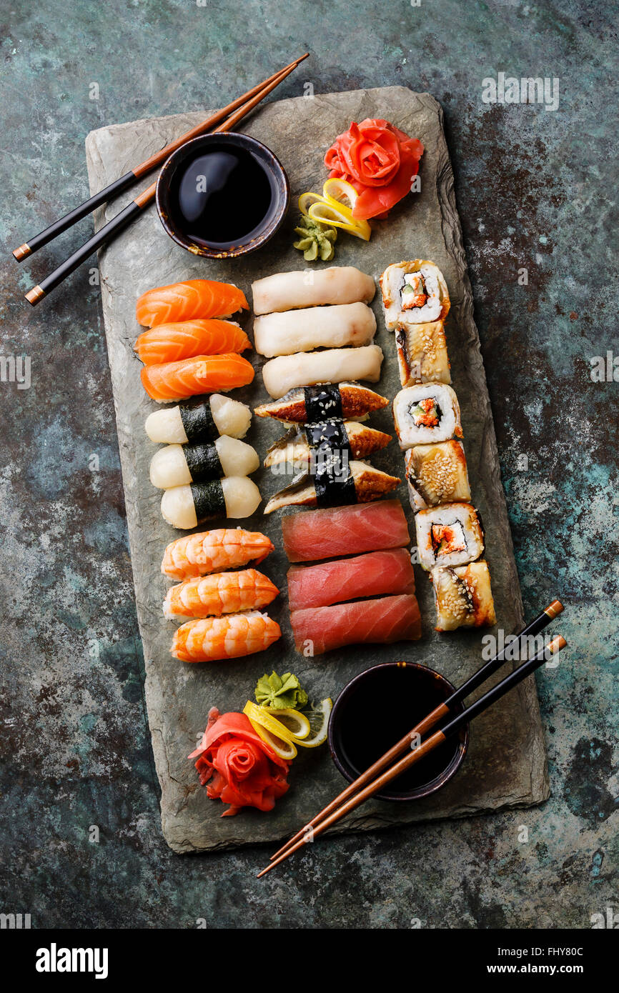 Sushi Set nigiri and sushi rolls served for two on gray stone slate on metal background Stock Photo