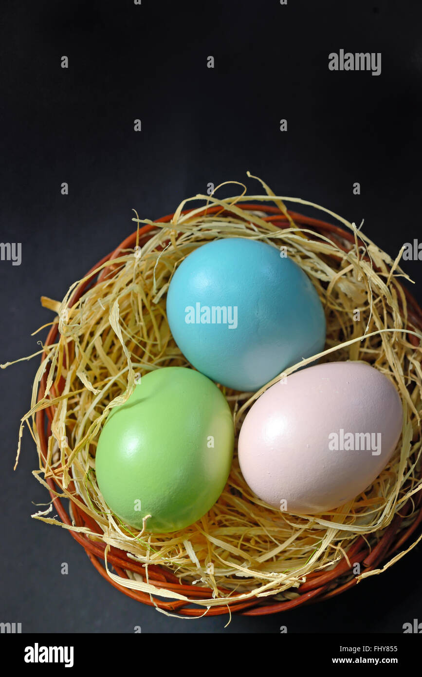 Easter eggs in the nest on black background Stock Photo - Alamy