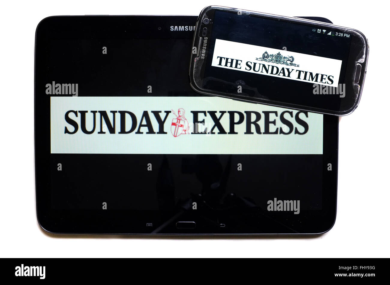 The logos of the Sunday Express and The Sunday Times newspapers displayed on the screens of a tablet and a smartphone. Stock Photo