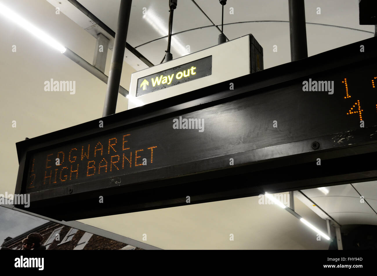 A departure board on a platform at a London Underground station Stock Photo