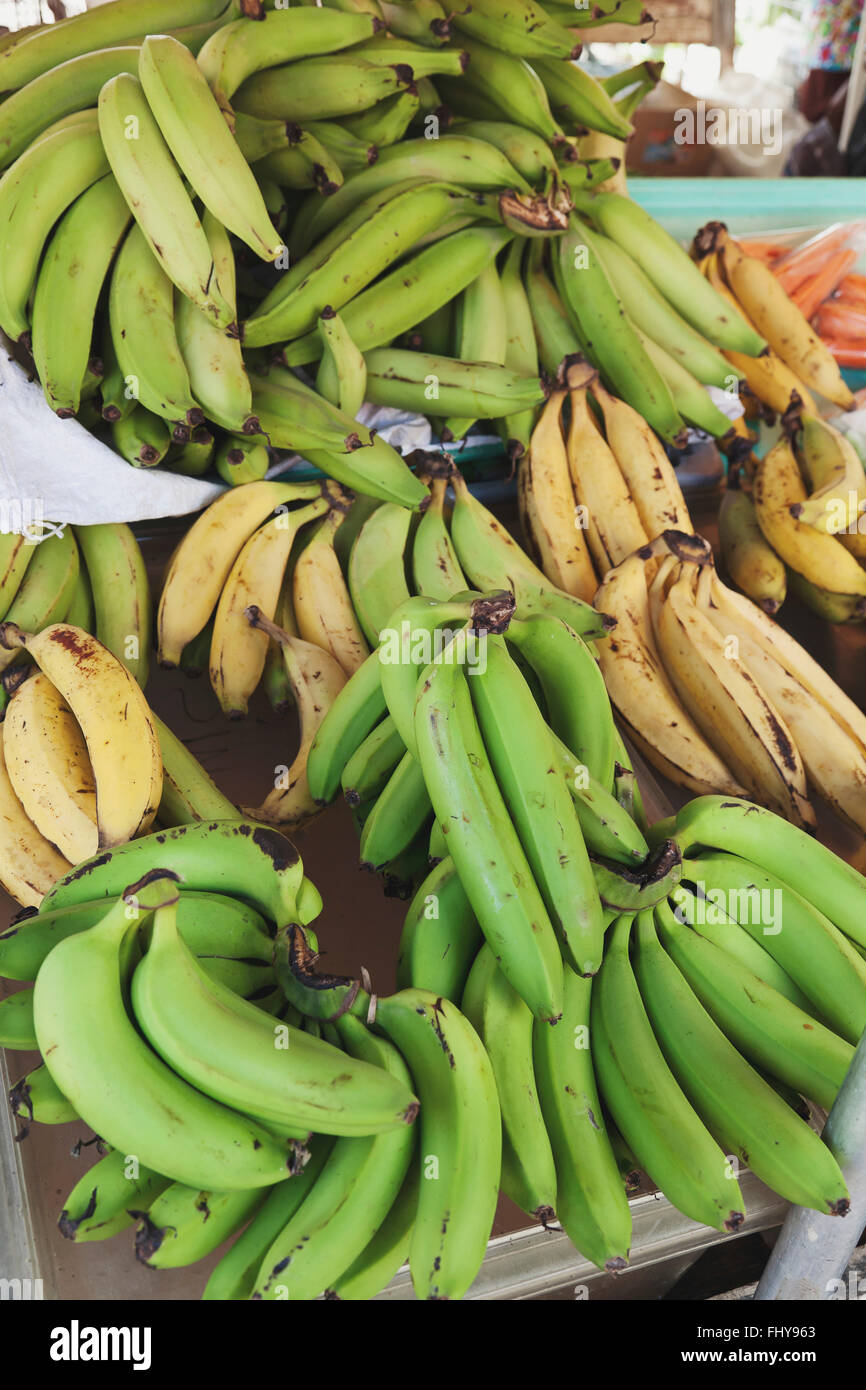 Green and yellow bananas on the green market Stock Photo