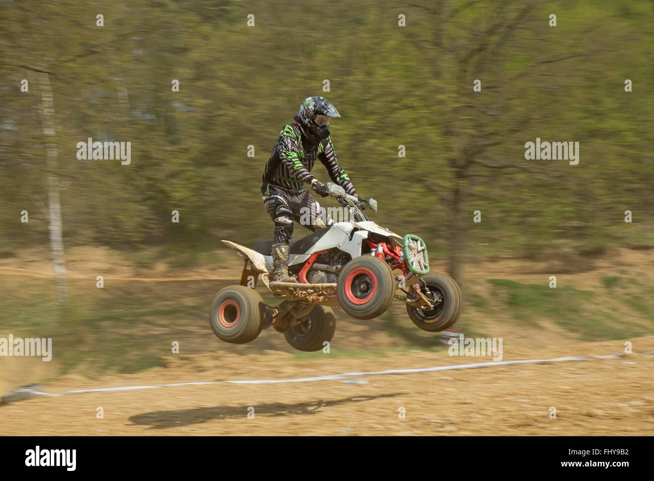 Dynamic shot of quad racer jumping a quad motorbike Stock Photo Alamy