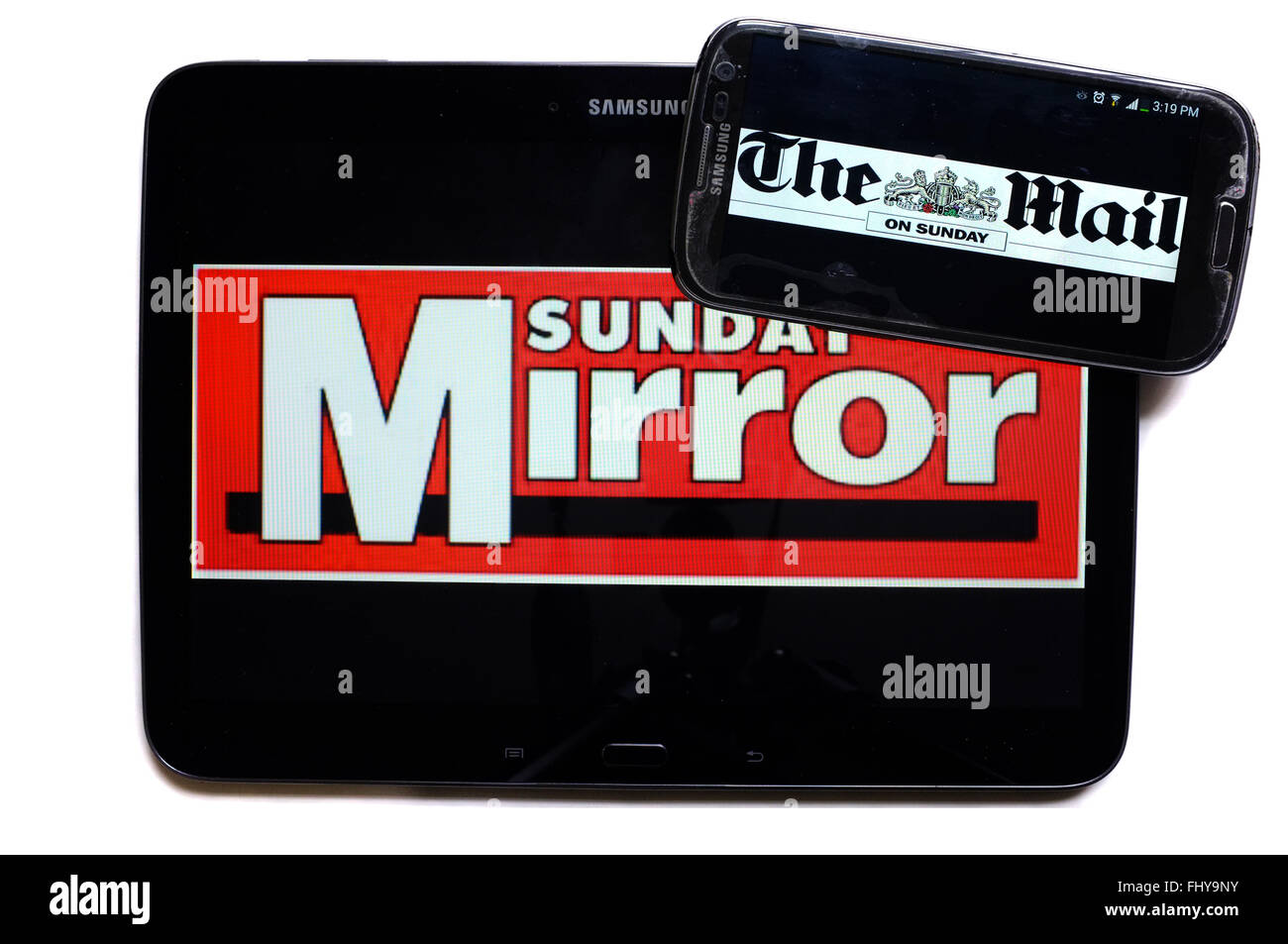 The logos of the Sunday Mirror and Mail on Sunday newspapers displayed on the screens of a tablet and a smartphone. Stock Photo