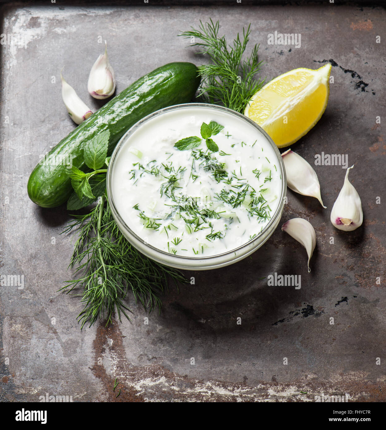 Tzatziki sauce with herbs and vegetables. Food background Stock Photo