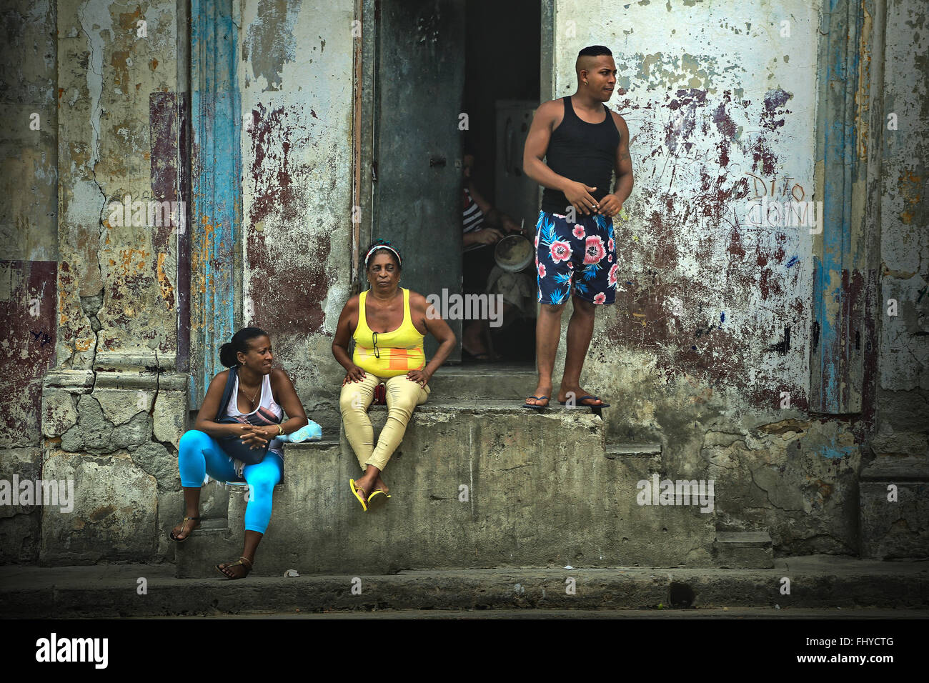 Cubans have a rest and talk on the street near the house, the Old Havana, Cuba Stock Photo