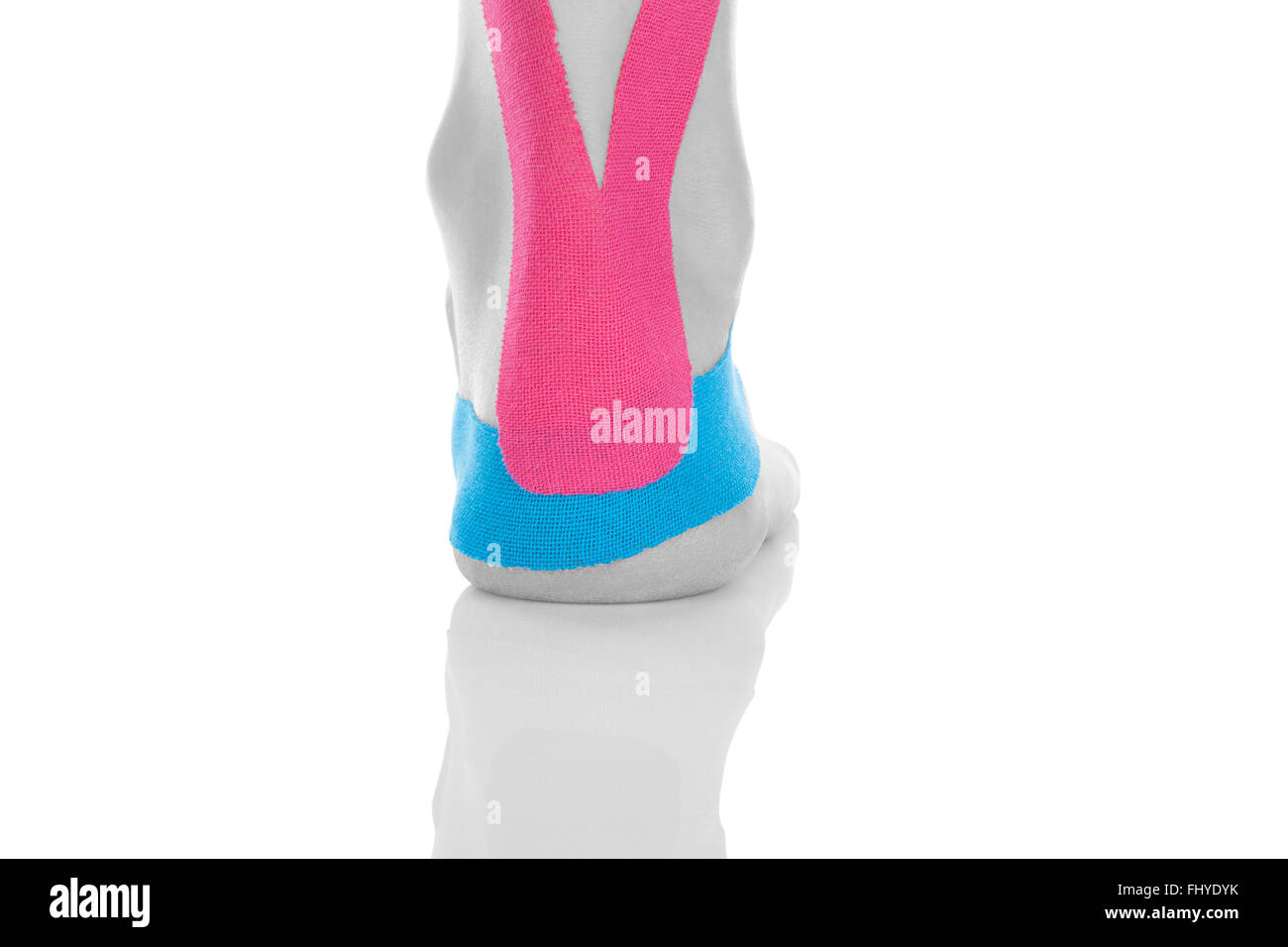Kinesio tape on female heel isolated on white background. Chronic pain