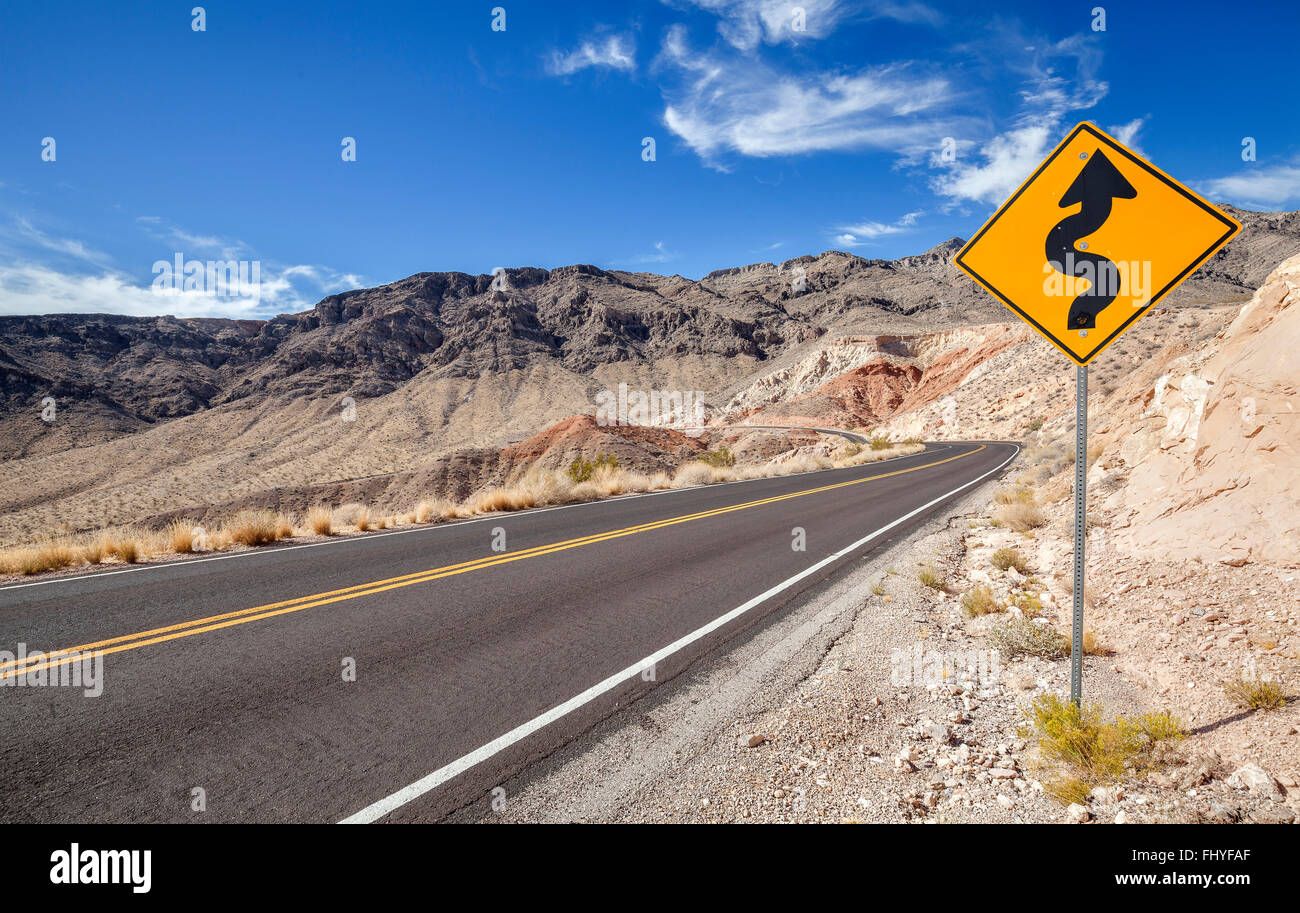 Picture of a winding road ahead sign. Stock Photo
