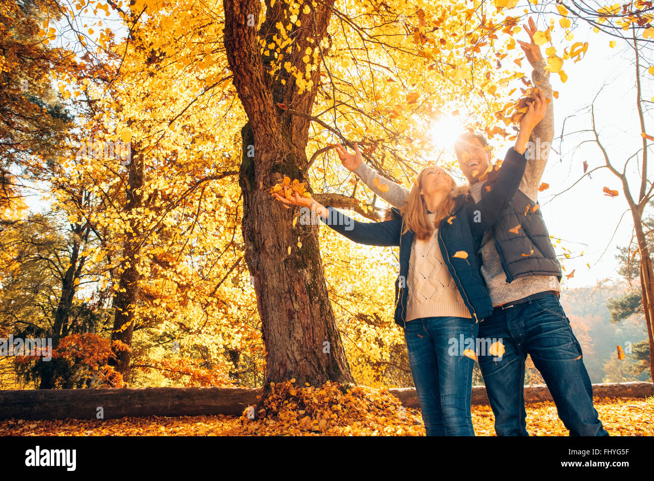 Happy couple having fun in autumn in a forest Stock Photo - Alamy