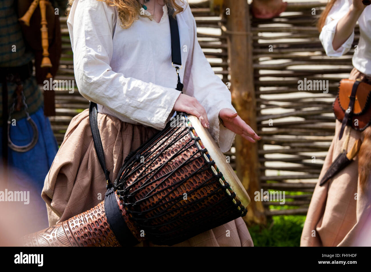 Girl playing on djembe drum Stock Photo