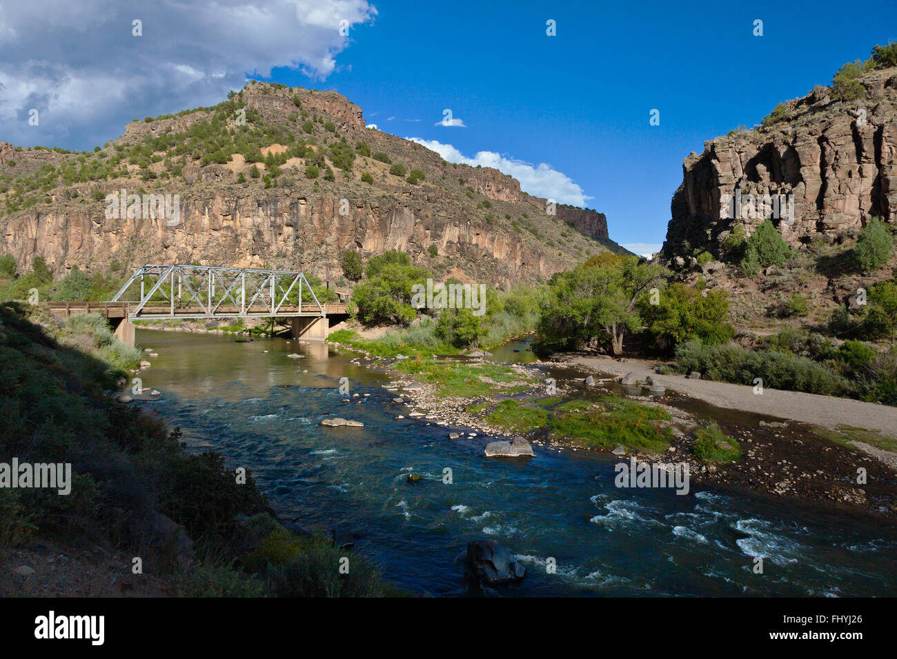 The RIO GRANDE RIVER runs through the TAOS GORGE under the JOHN DUNN BRIDGE- NEW MEXICO Stock Photo