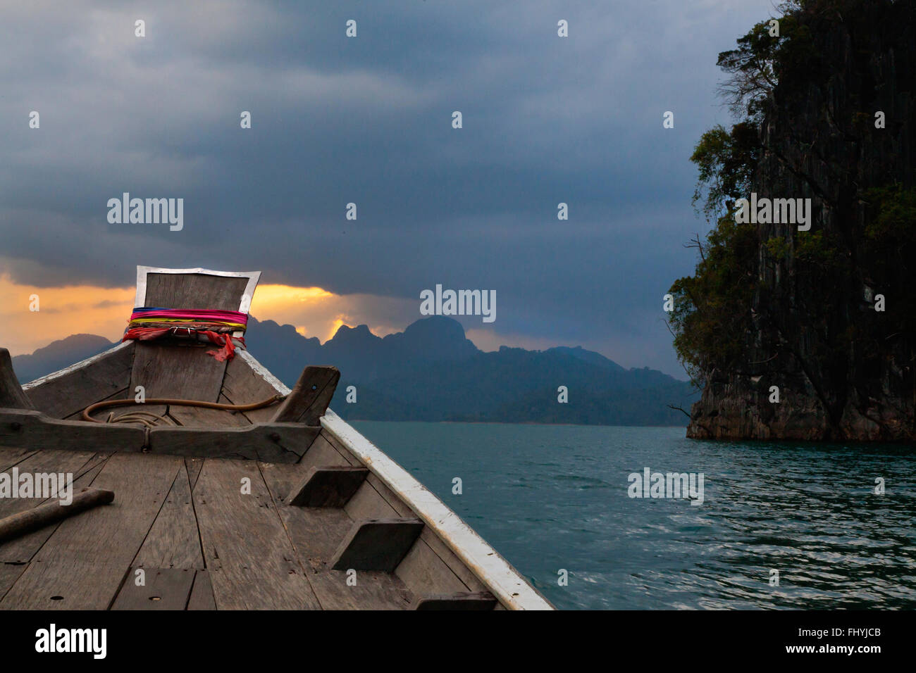 Boating at sunset on CHEOW EN LAKE in KHAO SOK NATIONAL PARK - THAILAND Stock Photo