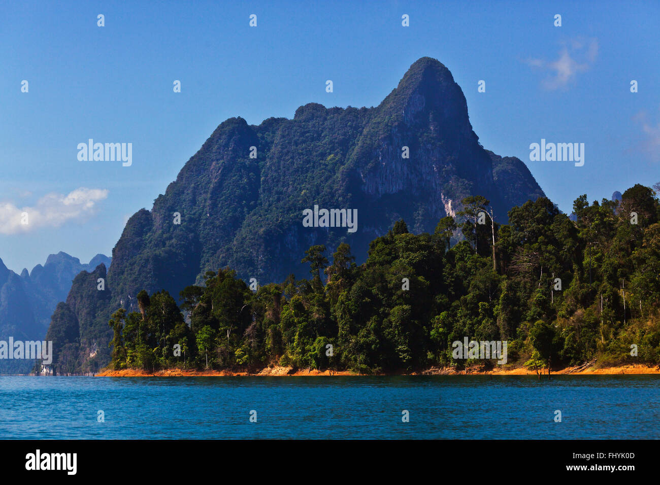 KARST FORMATIONS covered with tropical jungle surround CHEOW EN LAKE in KHAO SOK NATIONAL PARK - THAILAND Stock Photo