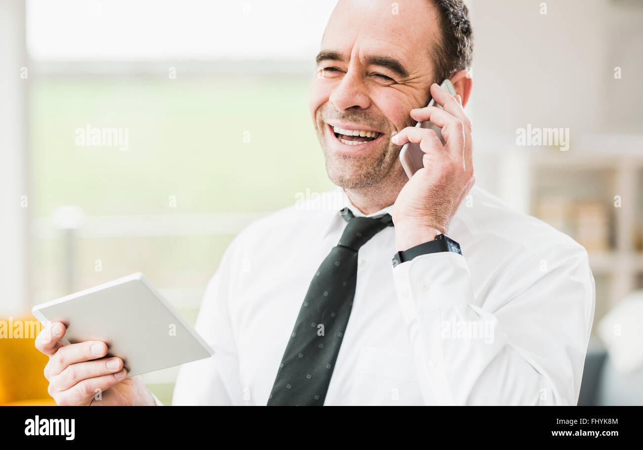 Happy businessman talking on cell phone Stock Photo