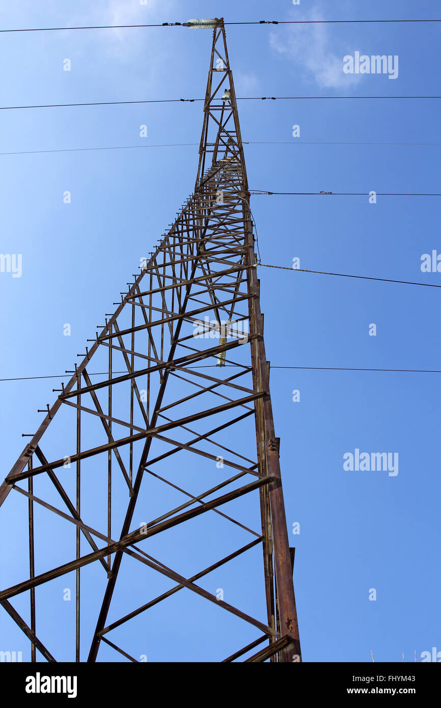 High voltage power pylons against blue sky Stock Photo - Alamy