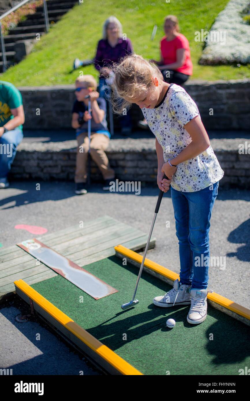 MODEL RELEASED. Girl playing mini golf. Stock Photo