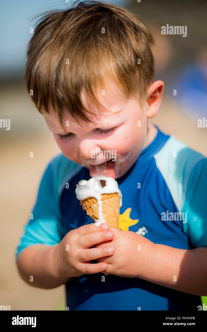 MODEL RELEASED. Young boy licking an ice cream. Stock Photo