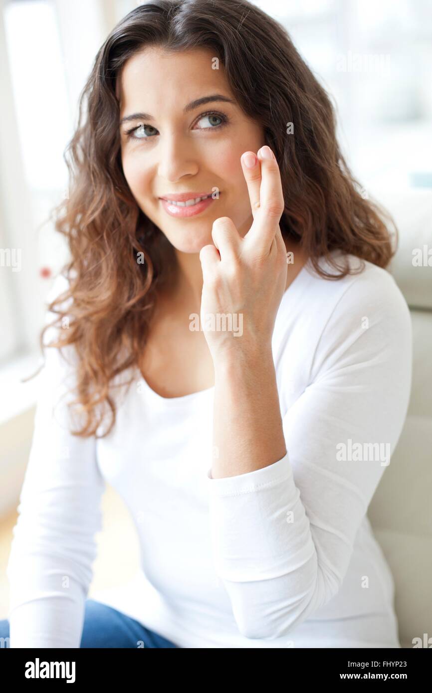 MODEL RELEASED. Mid adult woman crossing her fingers. Stock Photo