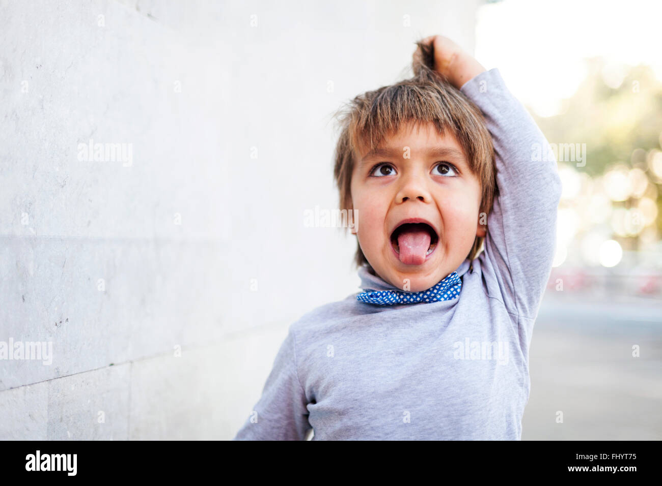 Little boy sticking out tongue while pulling funny face Stock Photo Alamy