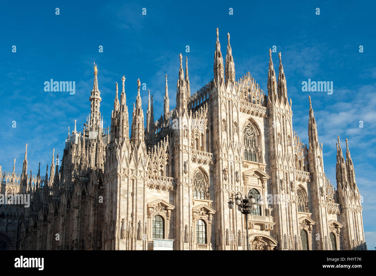 Front side of the Milan Cathedral under blue sky Stock Photo