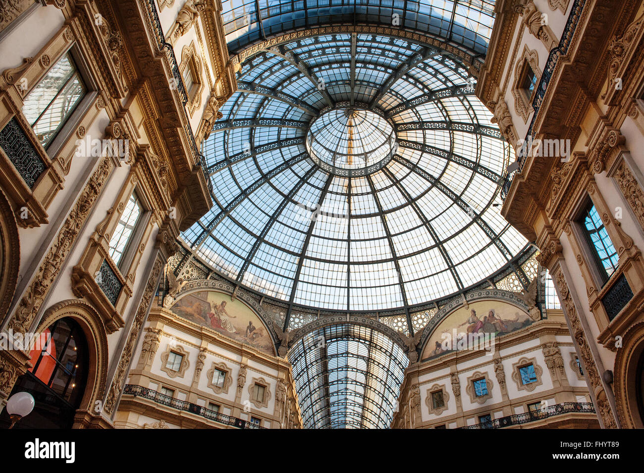 Low angle view toward circular domed ceiling and windows inside the Vittorio Emanuele Milan shopping mall interior Stock Photo